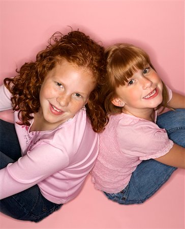 simsearch:400-03923096,k - Caucasian female children sitting back to back. Stock Photo - Budget Royalty-Free & Subscription, Code: 400-04448260