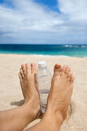 simsearch:400-04912125,k - Caucasian young adult woman feet and water bottle on beach. Stock Photo - Budget Royalty-Free & Subscription, Code: 400-04448273