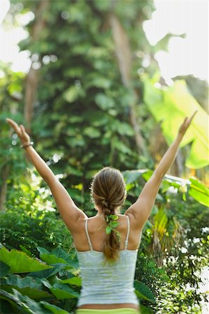 simsearch:400-04427380,k - Rear view of Caucasian mid-adult woman holding arms out in yoga position. Photographie de stock - Aubaine LD & Abonnement, Code: 400-04448362