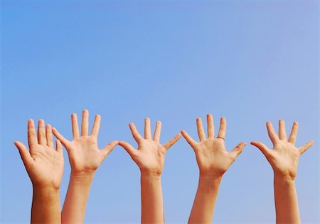 simsearch:400-04448769,k - Raised hands on blue sky background with copy space Stockbilder - Microstock & Abonnement, Bildnummer: 400-04448769