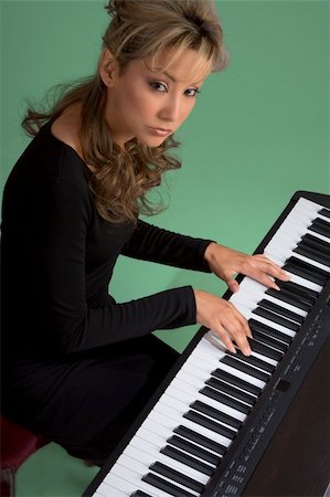 Young attractive Latina woman playing piano Stock Photo - Budget Royalty-Free & Subscription, Code: 400-04448978