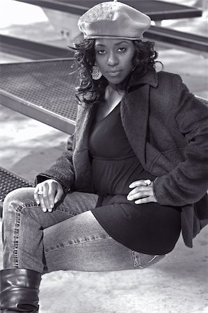 Portrait of Flirty African-American girl sitting on the bench Photographie de stock - Aubaine LD & Abonnement, Code: 400-04448983