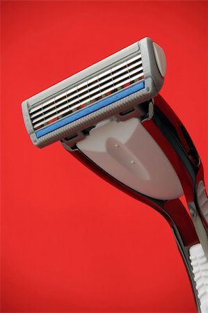 Brand new razor over red background Stock Photo - Budget Royalty-Free & Subscription, Code: 400-04449006