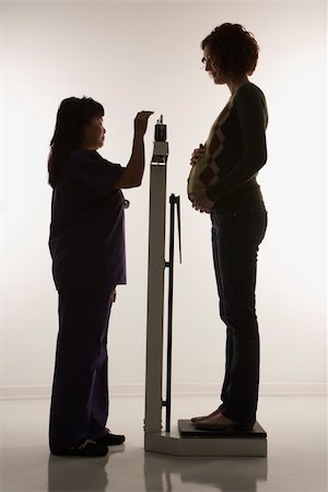 filipino nurse - Pregnant Caucasian mid-adult woman being weighed by nurse. Stock Photo - Budget Royalty-Free & Subscription, Code: 400-04449847