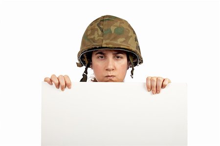 Serious soldier girl holding advertising space on white background Photographie de stock - Aubaine LD & Abonnement, Code: 400-04440032