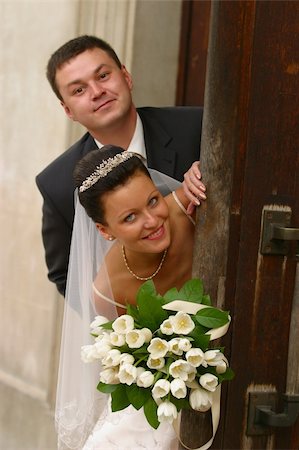 Beautiful newly married pair on a background of a wooden door Stock Photo - Budget Royalty-Free & Subscription, Code: 400-04440614