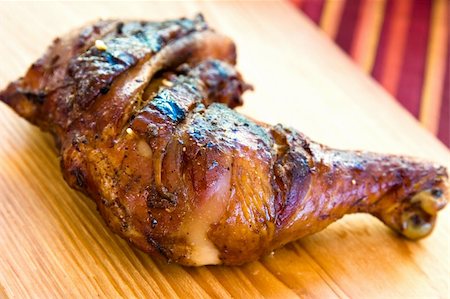 simsearch:400-04440947,k - Barbecued chicken leg also known as Jerk Chicken - Caribbean style. Shallow DOF. Fotografie stock - Microstock e Abbonamento, Codice: 400-04440947