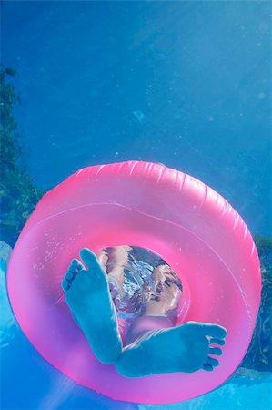 Woman's feet and rubber ring viewed from underwater Stock Photo - Budget Royalty-Free & Subscription, Code: 400-04441911