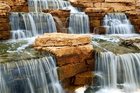 simsearch:400-04452321,k - Beautiful cascading waterfall over natural rocks, landscaping element Foto de stock - Royalty-Free Super Valor e Assinatura, Número: 400-04442352