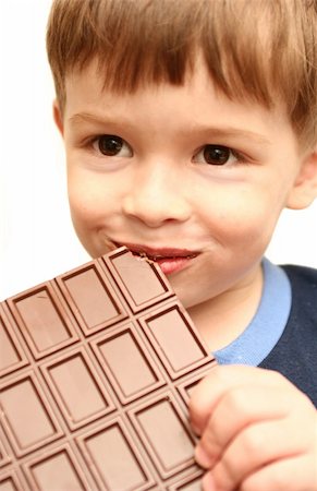 The boy eats a greater chocolate Stockbilder - Microstock & Abonnement, Bildnummer: 400-04442909