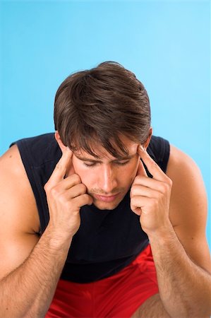 simsearch:400-04978521,k - portrait of a young man having a headache over blue background Stock Photo - Budget Royalty-Free & Subscription, Code: 400-04443184