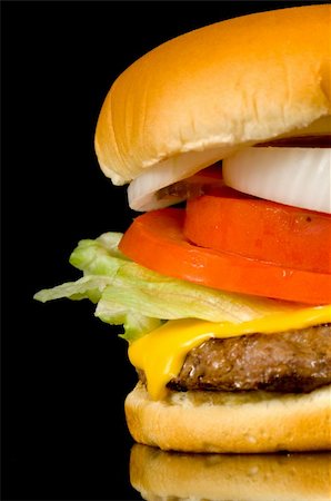 Hearty hamburger closup on black background - add black to the left for copy space Stock Photo - Budget Royalty-Free & Subscription, Code: 400-04454143