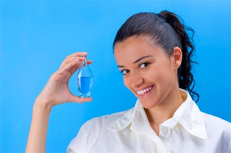 young pretty girl holding perfume Stock Photo - Budget Royalty-Free & Subscription, Code: 400-04454341