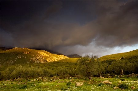 simsearch:400-08021518,k - Dramatic Greek landscape right after a storm with emerging rays of sun lighting the tip of the mountain Stock Photo - Budget Royalty-Free & Subscription, Code: 400-04454497