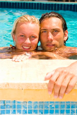 simsearch:400-04258029,k - attractive young couple relaxing by the pool Foto de stock - Royalty-Free Super Valor e Assinatura, Número: 400-04454950