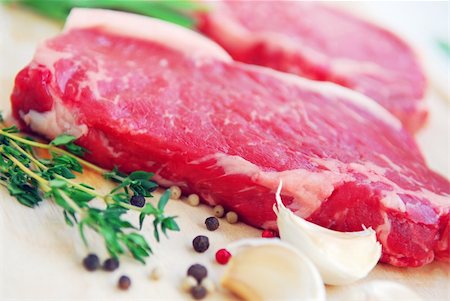 simsearch:400-04284643,k - Two raw new york steaks on cutting board with thyme peppercorns and garlic Stock Photo - Budget Royalty-Free & Subscription, Code: 400-04455126