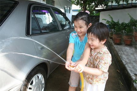Kids washing car in a sunny afternoon happily Stock Photo - Budget Royalty-Free & Subscription, Code: 400-04455312