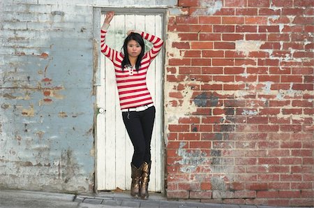 Asian girl posing against grungy urban wall Stock Photo - Budget Royalty-Free & Subscription, Code: 400-04455597