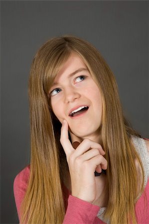 simsearch:400-04960190,k - Teenage girl posing on gray background with some attitude Stock Photo - Budget Royalty-Free & Subscription, Code: 400-04456087