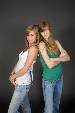 simsearch:400-04960190,k - Teenage girls posing on gray background with some attitude Photographie de stock - Aubaine LD & Abonnement, Code: 400-04456106