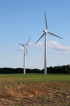 Two wind power generators in a field shot against a blue sky. Stock Photo - Budget Royalty-Free & Subscription, Code: 400-04457216