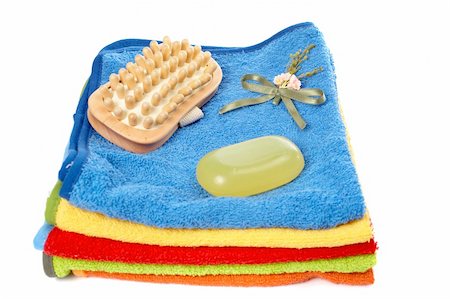 simsearch:400-06564793,k - Brush and tablet of soap on the multicolour towels stacked Photographie de stock - Aubaine LD & Abonnement, Code: 400-04457700