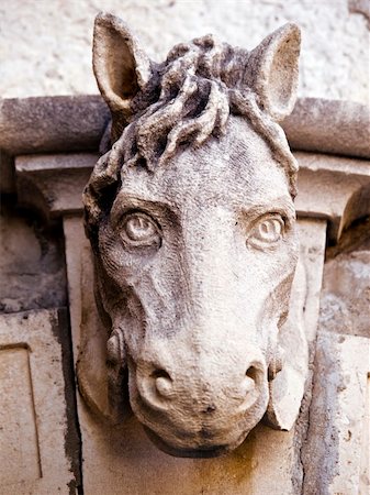 Old horse head sculpture made of stone at entrance of a house. Old Mediterranean house entrance in Dubrovnik. Close up. Stock Photo - Budget Royalty-Free & Subscription, Code: 400-04459510