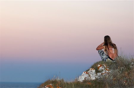 simsearch:400-05154191,k - girl in camouflage sitting on the sea coast and meditating Stock Photo - Budget Royalty-Free & Subscription, Code: 400-04459755