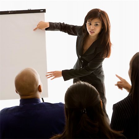 espetáculo amador - Vietnamese mid-adult woman standing in front of business group pointing to presentation. Foto de stock - Royalty-Free Super Valor e Assinatura, Número: 400-04450040