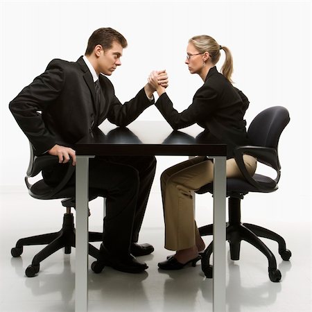 Side view of Caucasian mid-adult businessman and businesswoman arm wrestling on table. Stock Photo - Budget Royalty-Free & Subscription, Code: 400-04450050