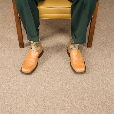 Close up of man sitting in chair wearing retro pants and shoes. Stock Photo - Budget Royalty-Free & Subscription, Code: 400-04450077