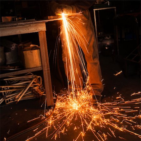 Metalsmith shaping metal and creating sparks. Stock Photo - Budget Royalty-Free & Subscription, Code: 400-04450267