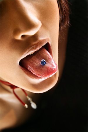 Close up portrait of young Caucasian woman sticking out pierced tongue. Photographie de stock - Aubaine LD & Abonnement, Code: 400-04450425