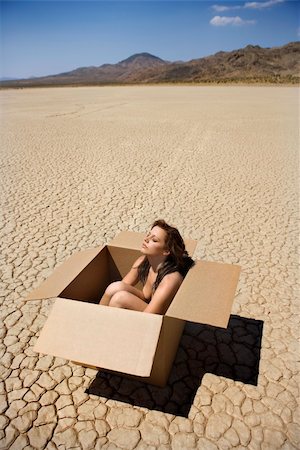 Pretty nude young woman sitting in box in cracked desert landscape in California. Stock Photo - Budget Royalty-Free & Subscription, Code: 400-04450499