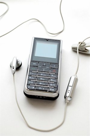 simsearch:400-04558697,k - A modern mobile phone and the wired head-phone Stockbilder - Microstock & Abonnement, Bildnummer: 400-04450597