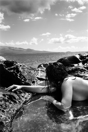 simsearch:400-04450899,k - Close up of nude Caucasian mid adult woman lying in tidal pool at Maui coast looking toward ocean. Stock Photo - Budget Royalty-Free & Subscription, Code: 400-04450795