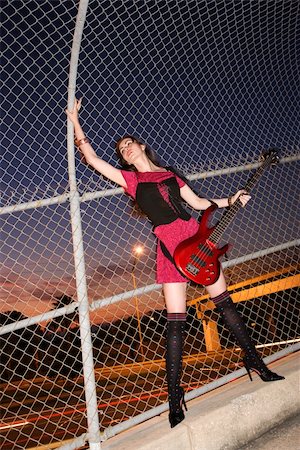 Caucasian young adult female holding electric guitar in skywalk. Stock Photo - Budget Royalty-Free & Subscription, Code: 400-04451159