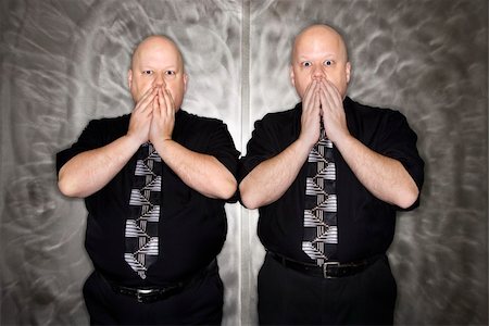 simsearch:693-06016281,k - Caucasian bald mid adult identical twin men gasping with hands over mouth. Stock Photo - Budget Royalty-Free & Subscription, Code: 400-04451219