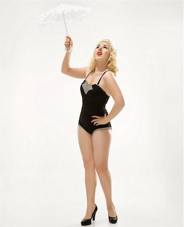 Attractive Caucasian woman wearing retro swimsuit in pinup pose with umbrella. Stock Photo - Budget Royalty-Free & Subscription, Code: 400-04451287