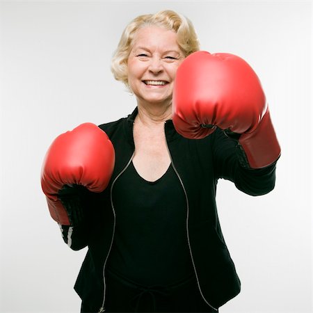 person punching for victory - Caucasian senior woman wearing boxing gloves and throwing punch at viewer. Stock Photo - Budget Royalty-Free & Subscription, Code: 400-04451298