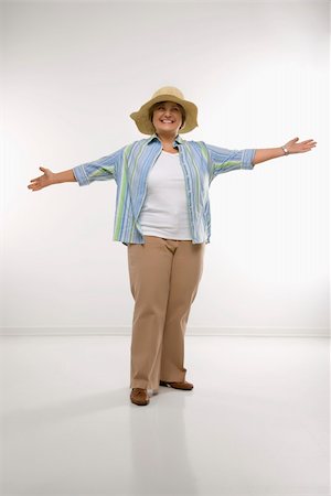 Caucasian middle aged woman wearing straw hat holding arms outstretched. Stock Photo - Budget Royalty-Free & Subscription, Code: 400-04451293