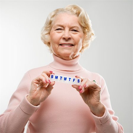 pillbox - Caucasian senior woman holding pill box and smiling at viewer. Stock Photo - Budget Royalty-Free & Subscription, Code: 400-04451323
