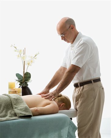 simsearch:400-04956215,k - Caucasian middle-aged male massage therapist massaging back of Caucasian middle-aged woman lying on massage table. Photographie de stock - Aubaine LD & Abonnement, Code: 400-04451358
