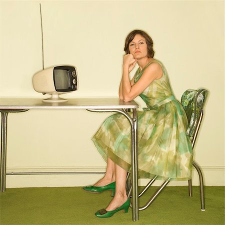 dinette - Pretty Caucasian mid-adult woman wearing green vintage dress sitting at 50's retro dinette in front of old televsion looking bored. Stock Photo - Budget Royalty-Free & Subscription, Code: 400-04451376
