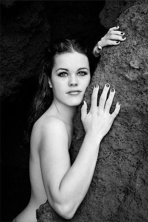 simsearch:400-03940673,k - Young nude Caucasian woman leaning against rock and looking at viewer. Stock Photo - Budget Royalty-Free & Subscription, Code: 400-04451725