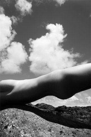 simsearch:400-04955255,k - Close up torso of young Caucasian nude woman partially holding self up on rocky Maui coast. Stockbilder - Microstock & Abonnement, Bildnummer: 400-04451721