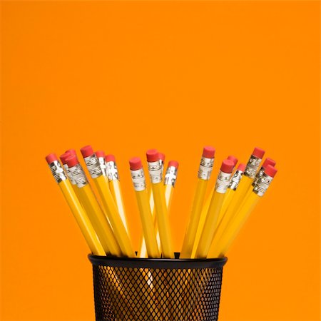 simsearch:400-04451935,k - Group of pencils in pencil holder on orange background. Fotografie stock - Microstock e Abbonamento, Codice: 400-04451937