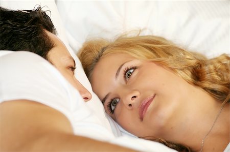 a attractive young couple is smiling in their bed at home Stock Photo - Budget Royalty-Free & Subscription, Code: 400-04451944