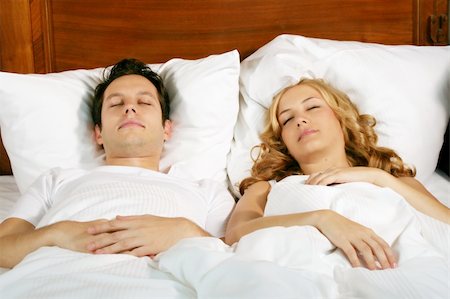 a attractive young couple is sleeping in their bed at home Stock Photo - Budget Royalty-Free & Subscription, Code: 400-04451940