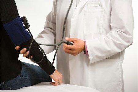 Asian American male doctor testing blood pressure of Caucasian woman. Stock Photo - Budget Royalty-Free & Subscription, Code: 400-04452037